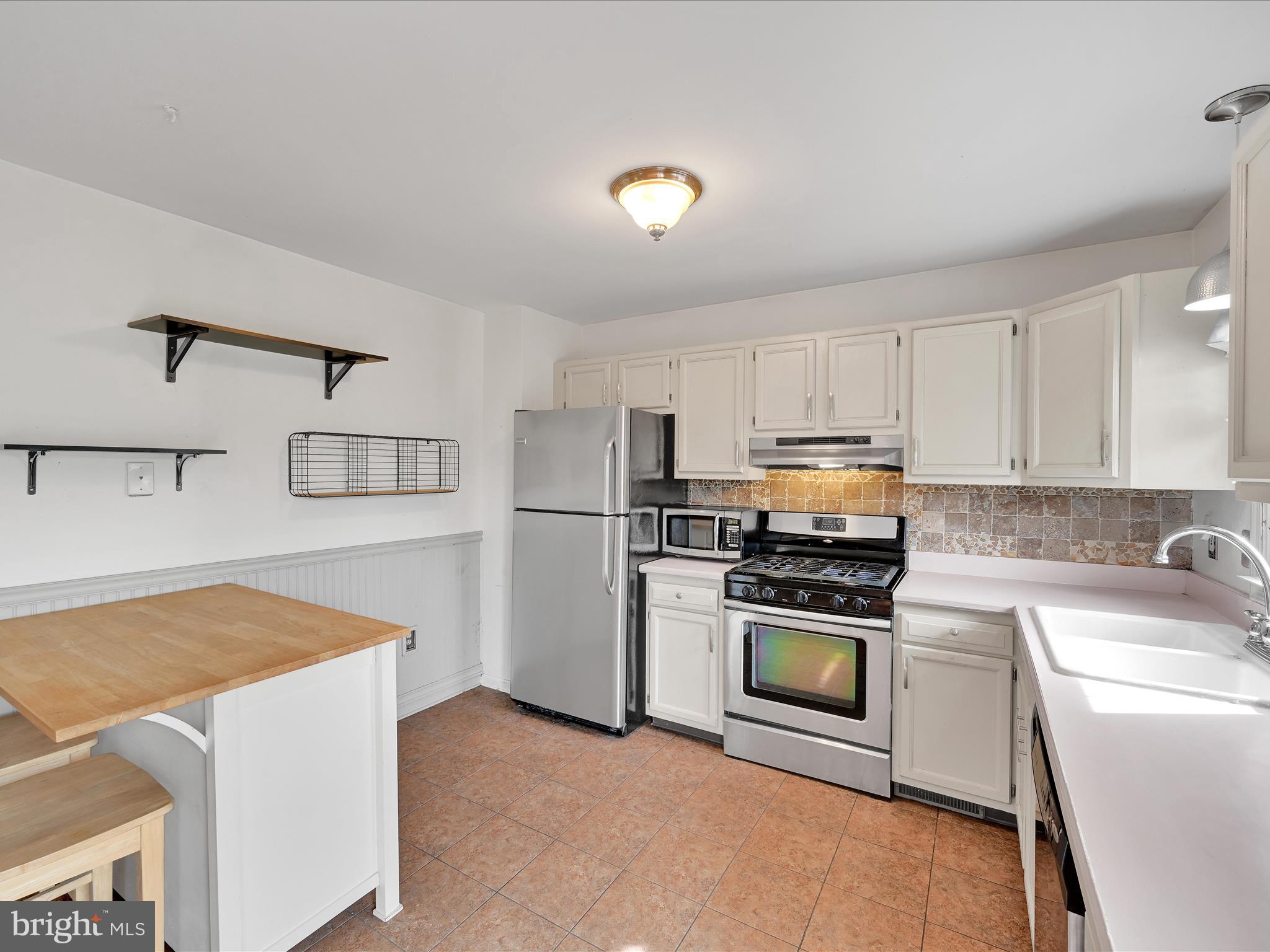 2140 Walnut Street Lebanon, PA 17042 - Photo 11 of 26 a kitchen with a stove a sink and a refrigerator