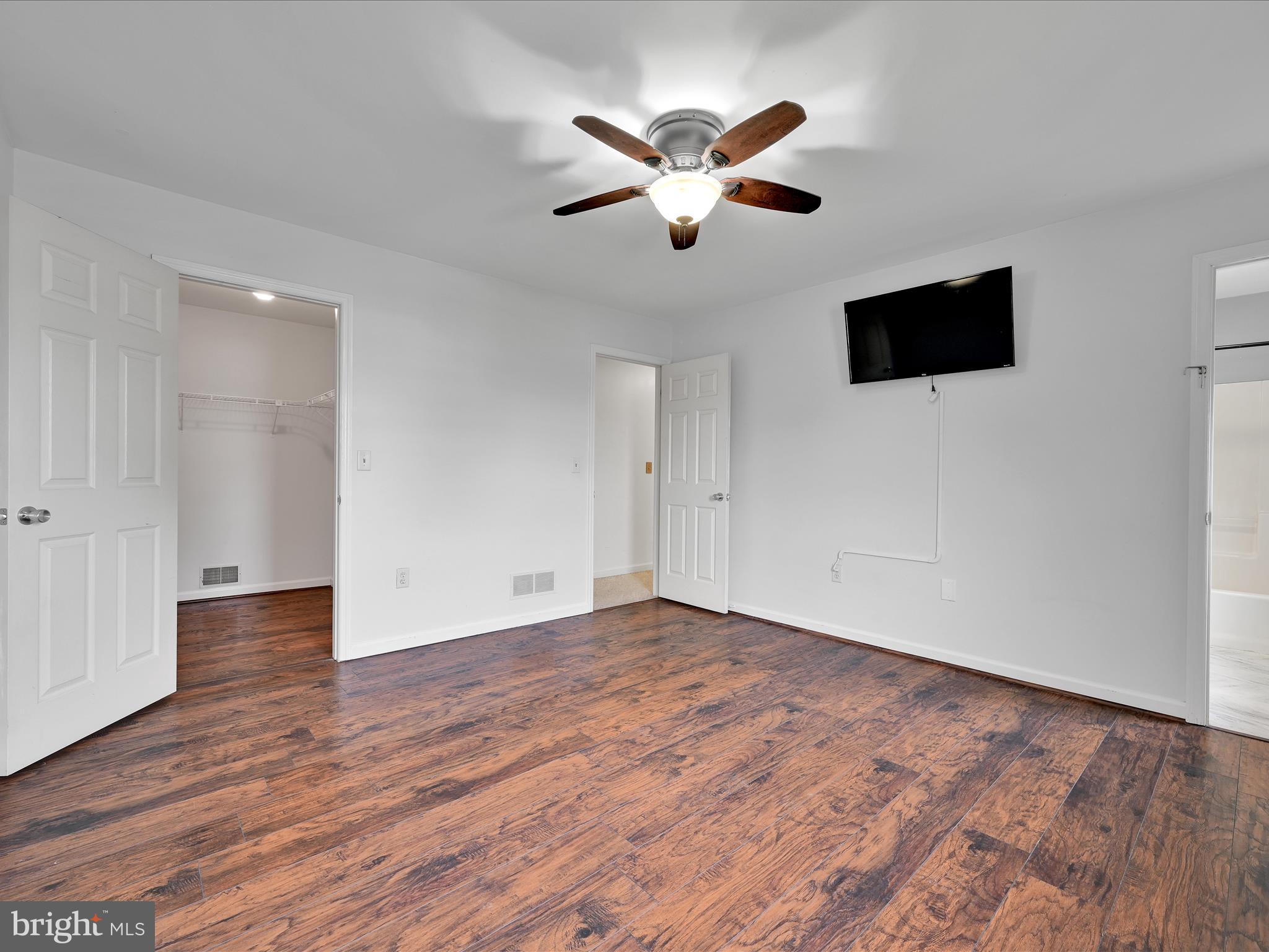 2140 Walnut Street Lebanon, PA 17042 - Photo 16 of 26 a view of an empty room with wooden floor and a ceiling fan