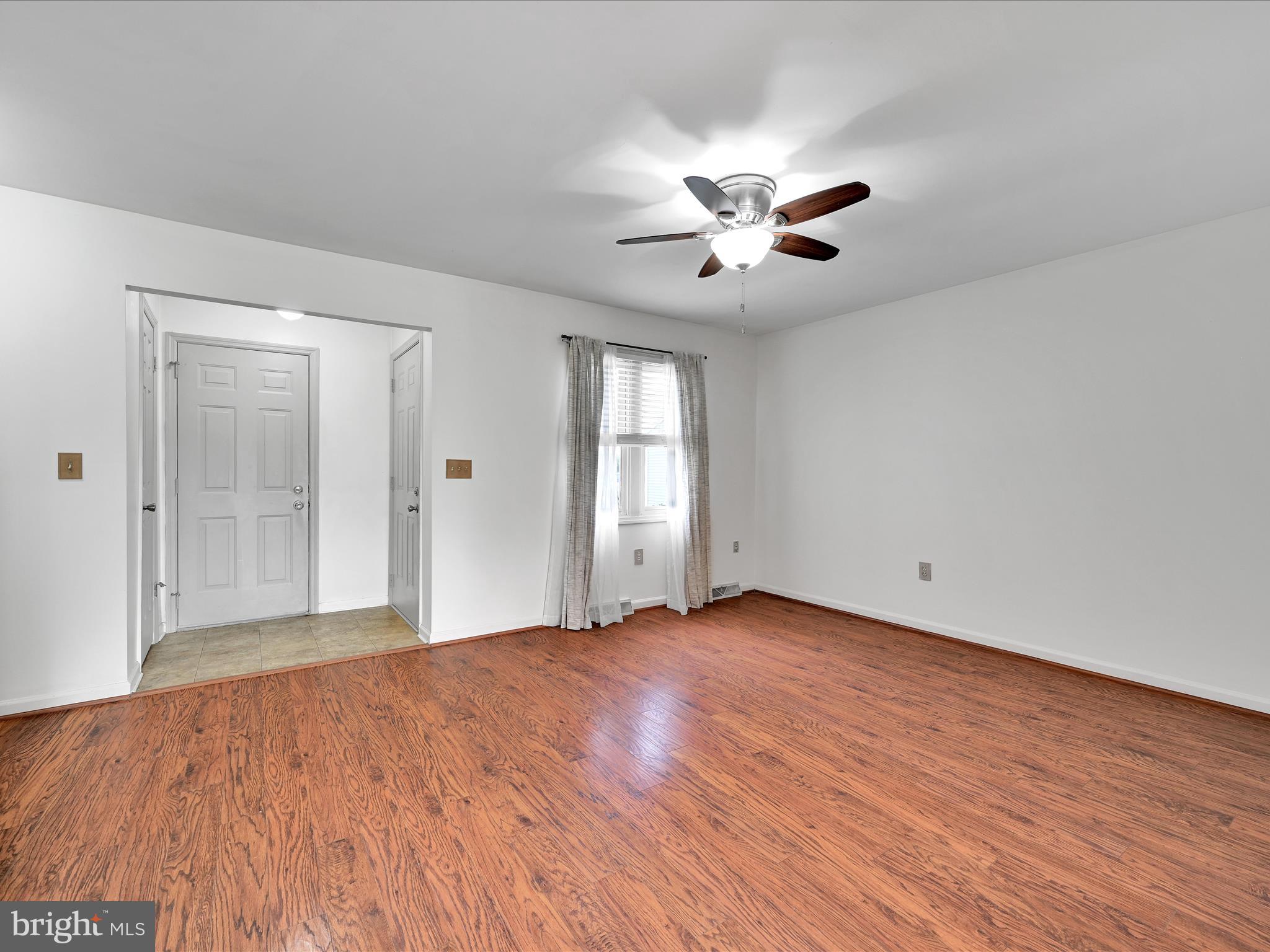 2140 Walnut Street Lebanon, PA 17042 - Photo 6 of 26 a view of an empty room with chandelier fan and a window