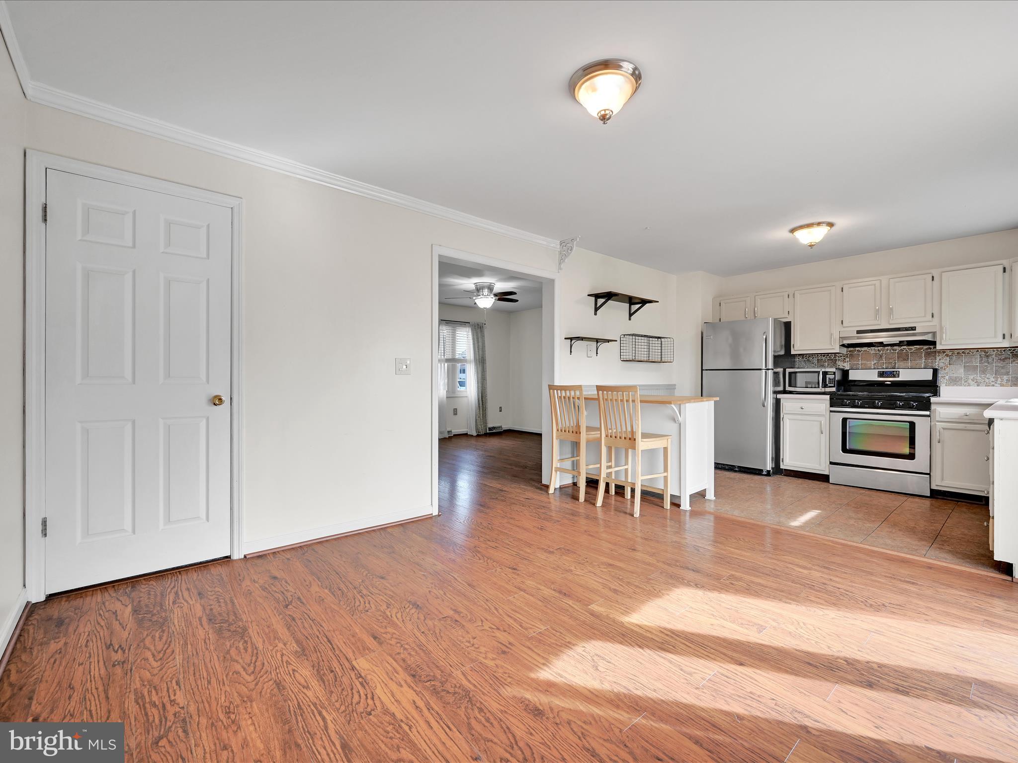 2140 Walnut Street Lebanon, PA 17042 - Photo 9 of 26 a view of kitchen with stainless steel appliances kitchen island empty cabinets and wooden floor