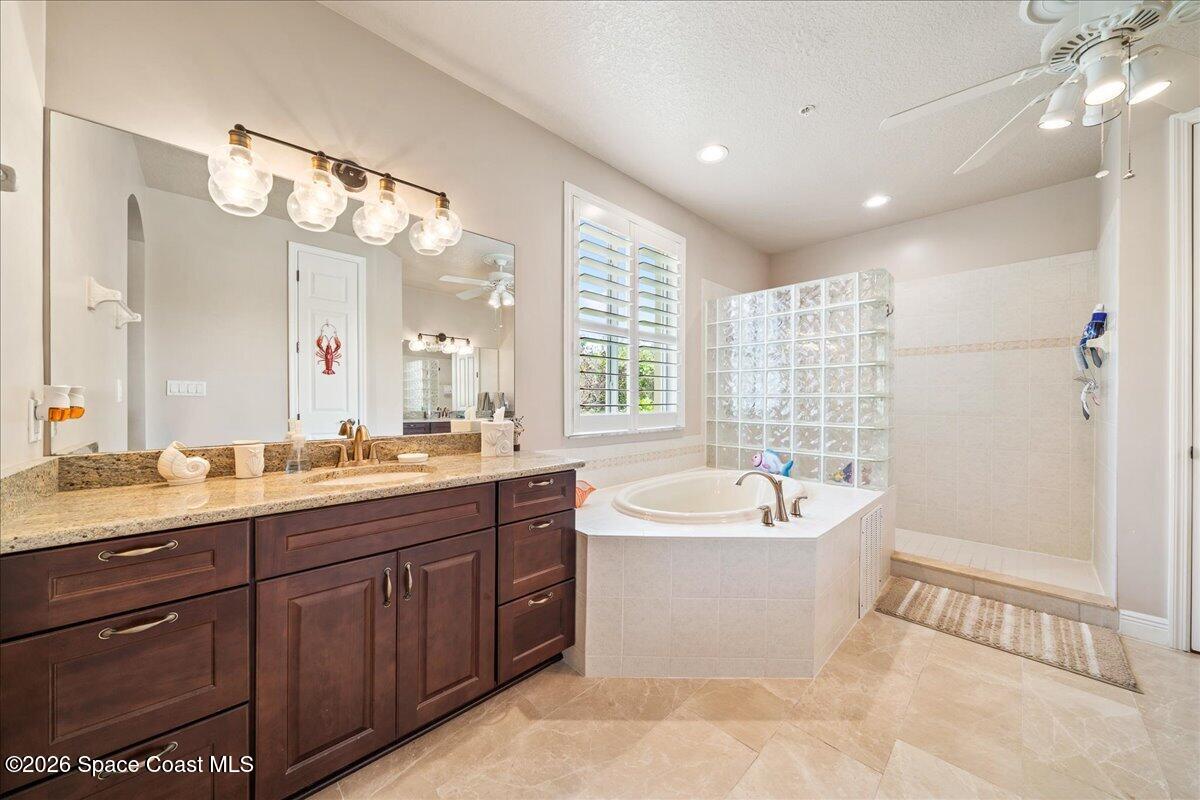 6005 Highway 1, Unit 101 Rockledge, FL 32955 - Photo 21 of 57 a spacious bathroom with a bathtub a double vanity sink a mirror and a bathtub