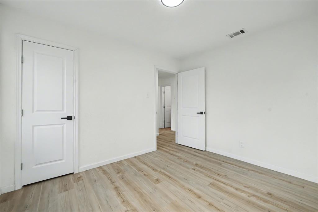 11446 Lippitt Avenue Dallas, TX 75218 - Photo 22 of 26 a view of an empty room with wooden floor