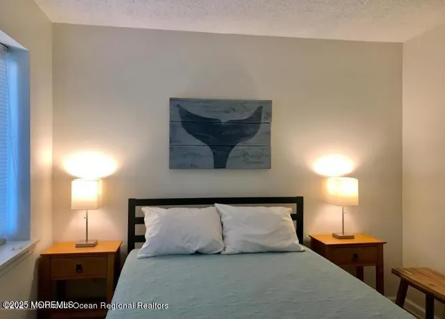 a bedroom with a bed and a lamp