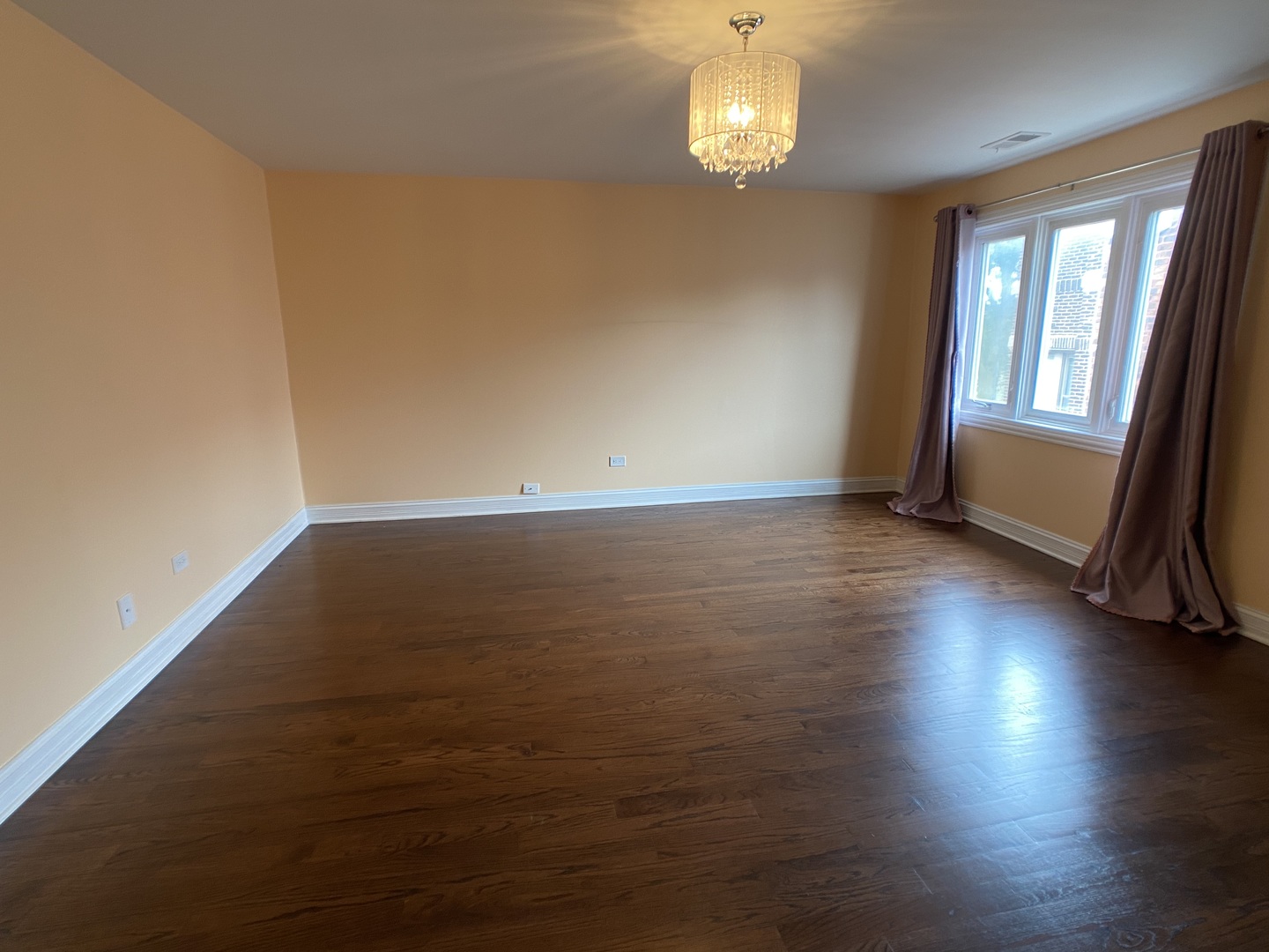 2949 South Halsted Street, Unit B Chicago, IL 60608 - Photo 11 of 22 an empty room with wooden floor and windows