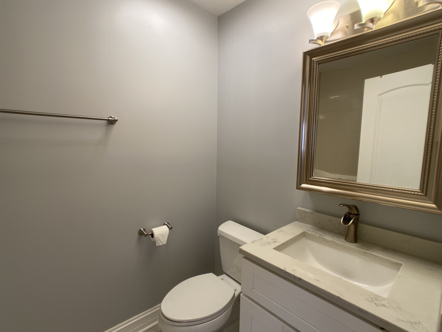 2949 South Halsted Street, Unit B Chicago, IL 60608 - Photo 12 of 22 a bathroom with a sink a toilet and mirror