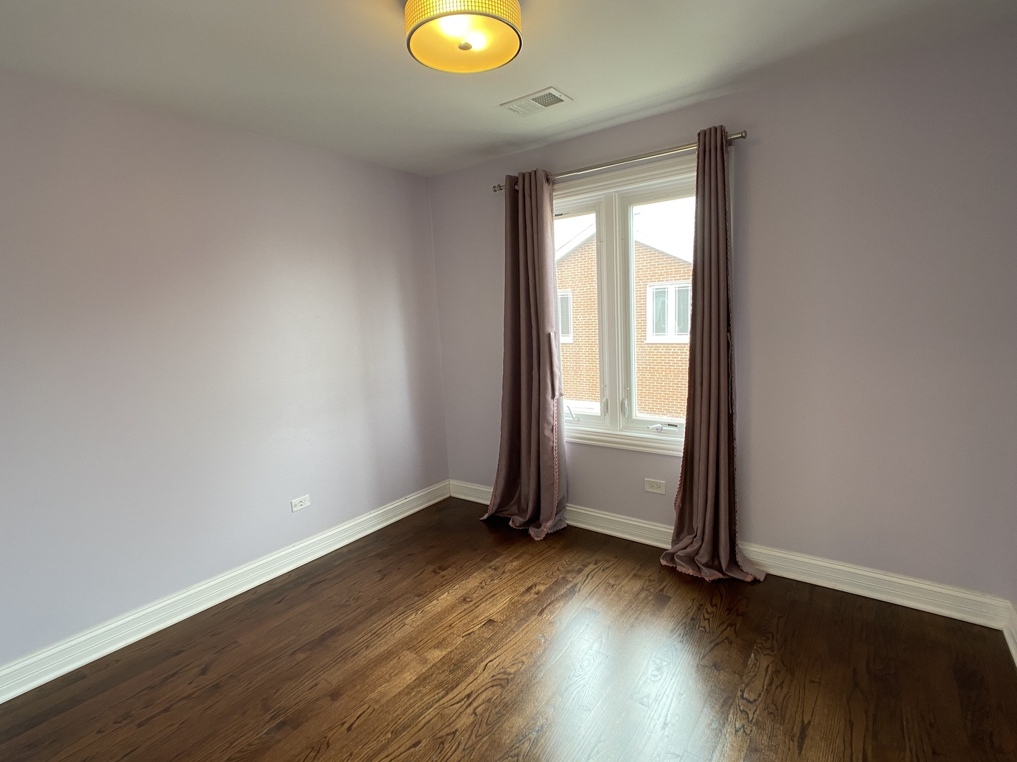 2949 South Halsted Street, Unit B Chicago, IL 60608 - Photo 18 of 22 an empty room with wooden floor and windows