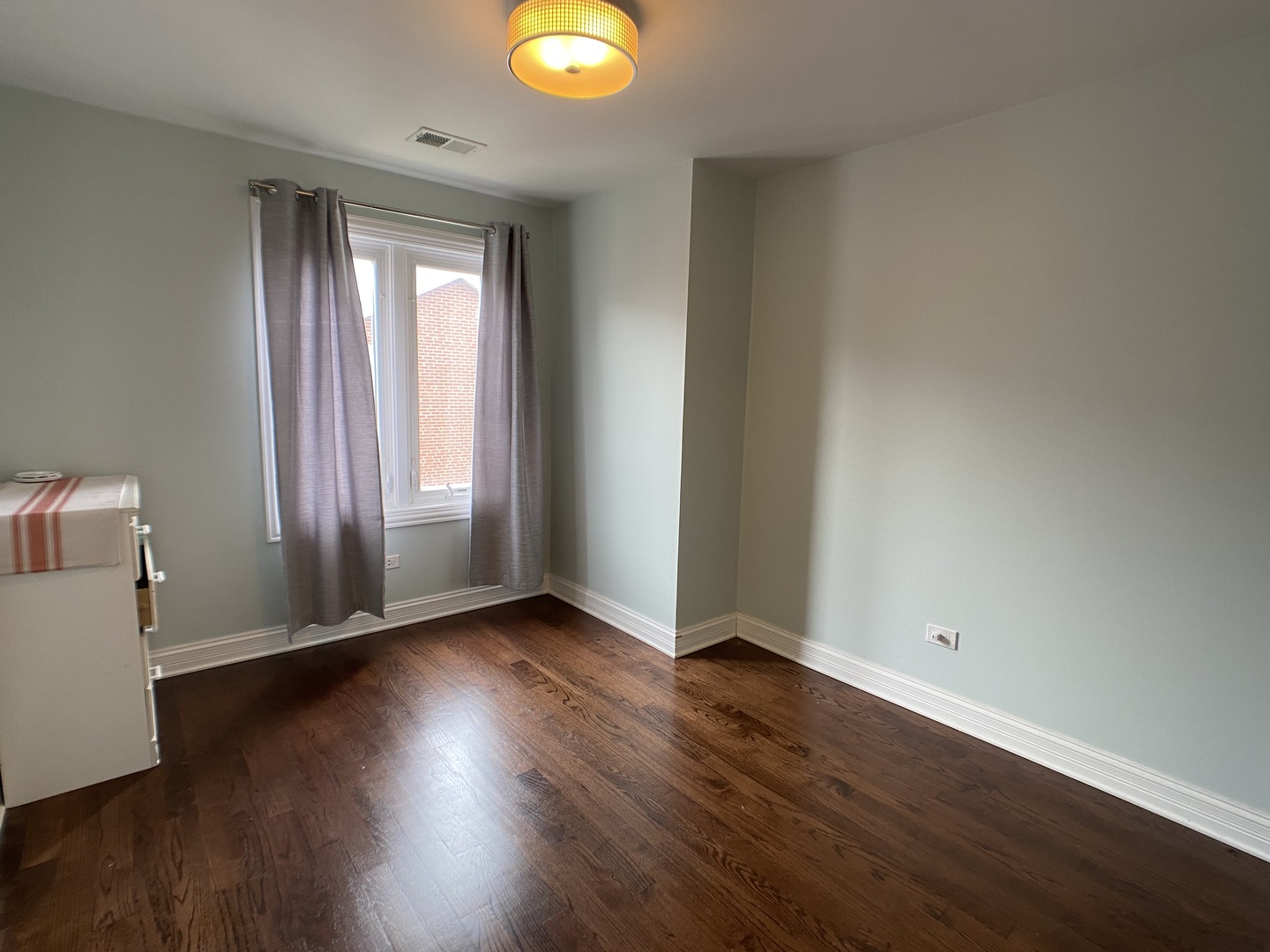 2949 South Halsted Street, Unit B Chicago, IL 60608 - Photo 19 of 22 an empty room with wooden floor and windows