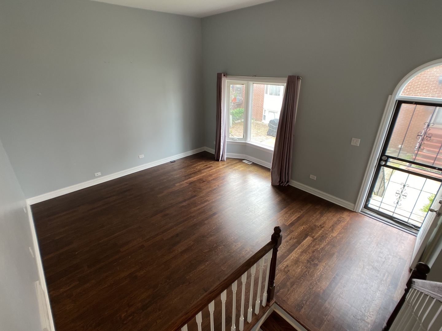 2949 South Halsted Street, Unit B Chicago, IL 60608 - Photo 8 of 22 a view of an empty room with wooden floor and a window