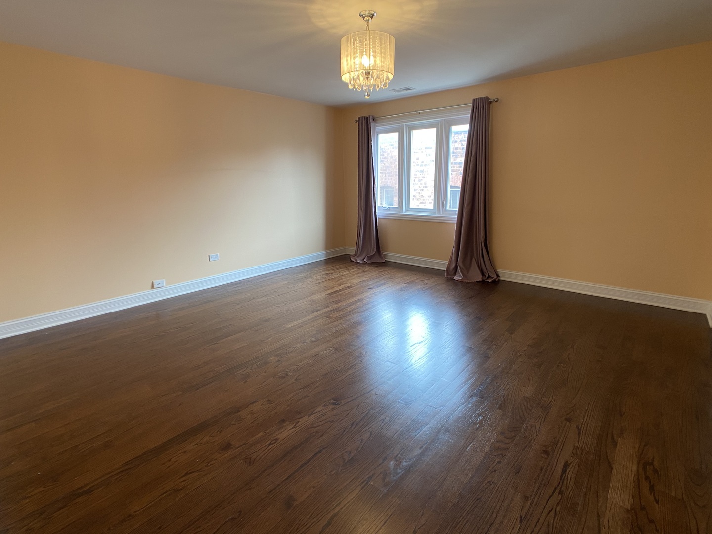 2949 South Halsted Street, Unit B Chicago, IL 60608 - Photo 10 of 22 an empty room with wooden floor and windows