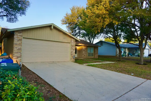 a view of a house with a yard and garage