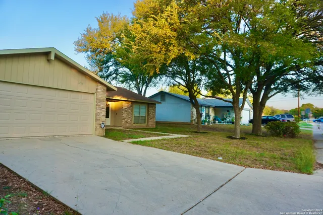 a yellow house in middle of the forest