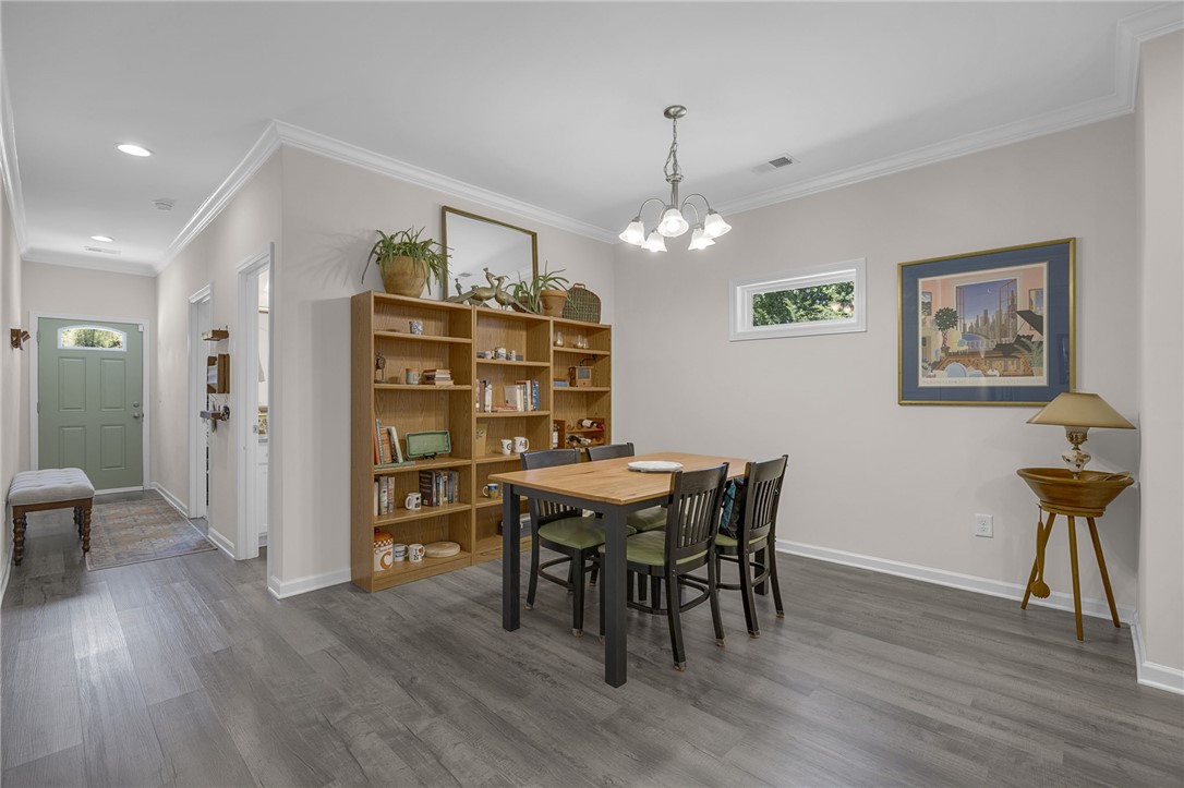 430 Johnson Road Central, SC 29630 - Photo 4 of 36 Hardwood-style flooring extends through the dining area, creating a cohesive and inviting space.
