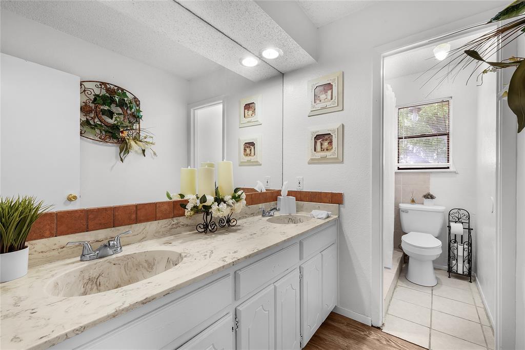 748 Rocky Ridge Lane Weatherford, TX 76085 - Photo 12 of 38 a bathroom with a toilet sink and mirror