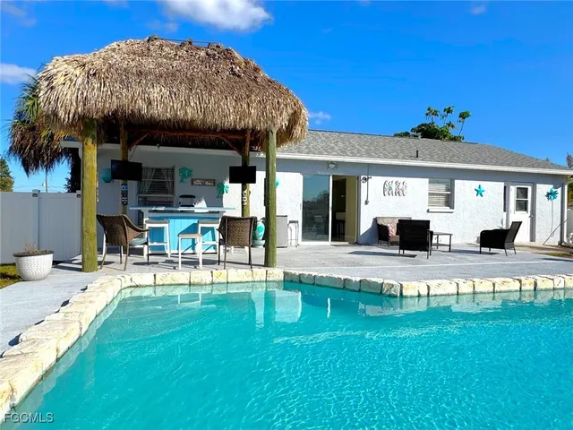 a view of a house with a backyard patio and sitting area