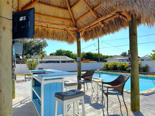 a kitchen with stainless steel appliances kitchen island granite countertop a table and chairs in it