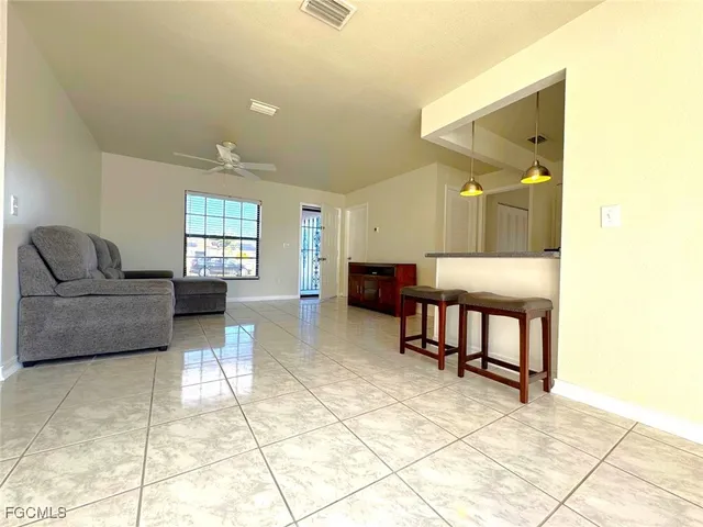 a living room with furniture and a dining table