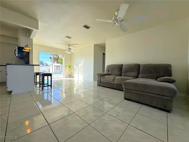 a living room with furniture and a dining table