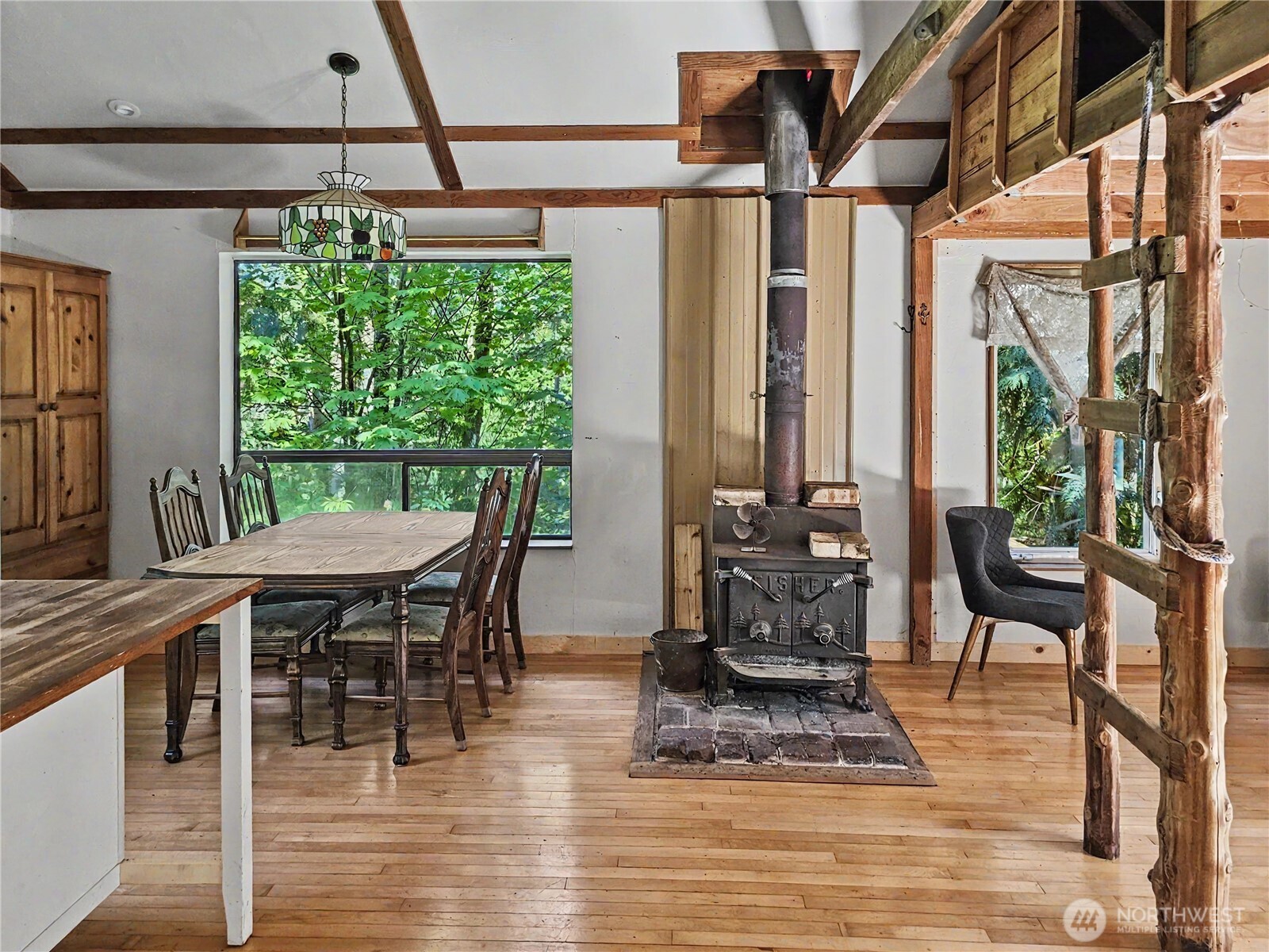 313 Larch Road Quilcene, WA 98376 - Photo 2 of 20 a dining room with furniture window and wooden floor