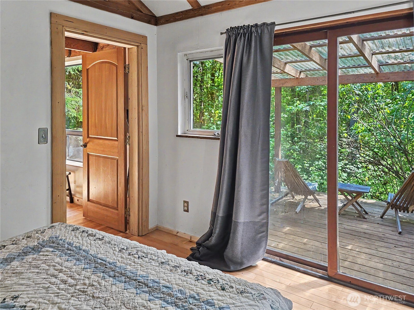 313 Larch Road Quilcene, WA 98376 - Photo 7 of 20 a bedroom with a bed and wooden floor