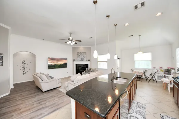 a living room with furniture a table and wooden floor