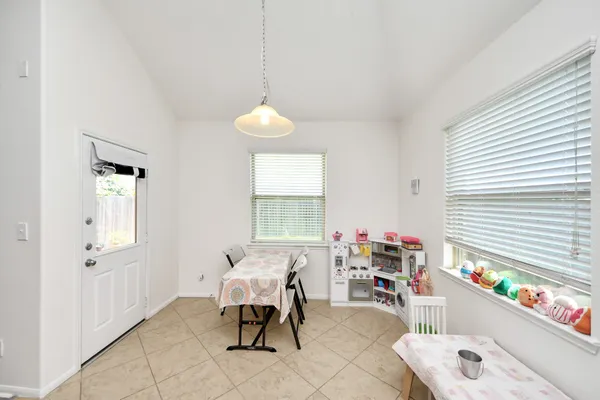a living room with furniture a rug and white walls