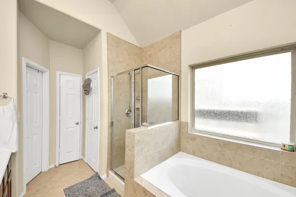a en suite bathroom with a double vanity sink and a mirror
