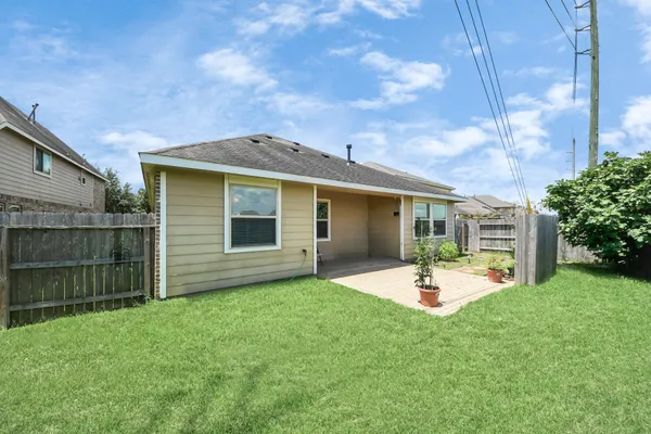 a view of a backyard with sitting area and garden
