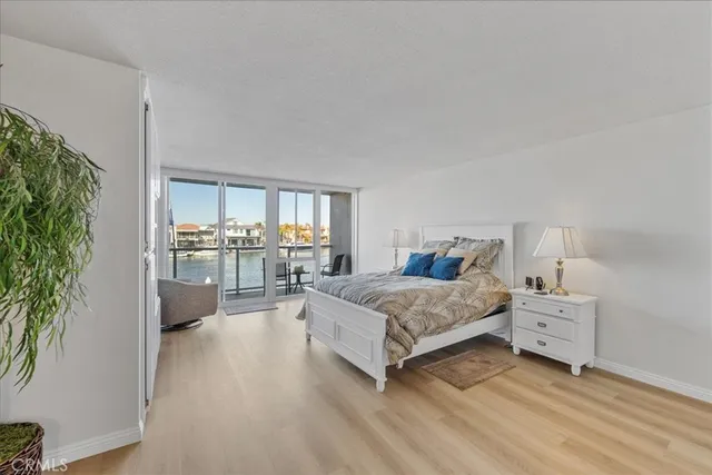 a bedroom with a bed and a potted plant