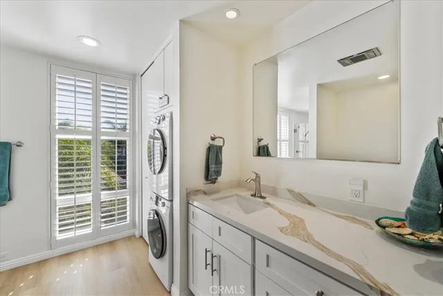 a spacious bathroom with a granite countertop sink and a mirror