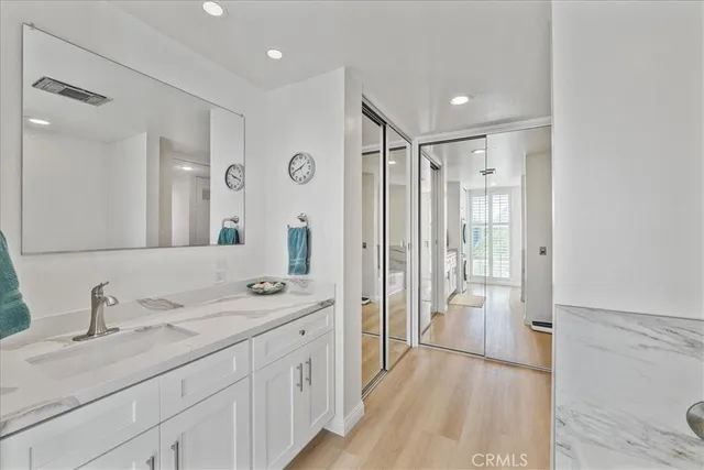 a bathroom with a double vanity sink mirror double and shower