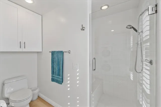 a bathroom with a toilet and a shower