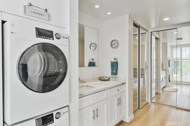 a bathroom with a sink a washer and dryer