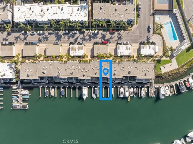 a view of a swimming pool with lawn chairs and couches