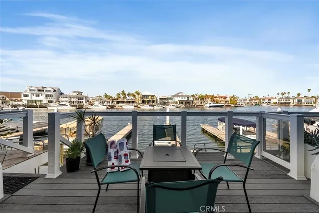 a view of a chairs and table on wooden deck with city view