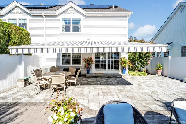 a front view of a house with sitting area