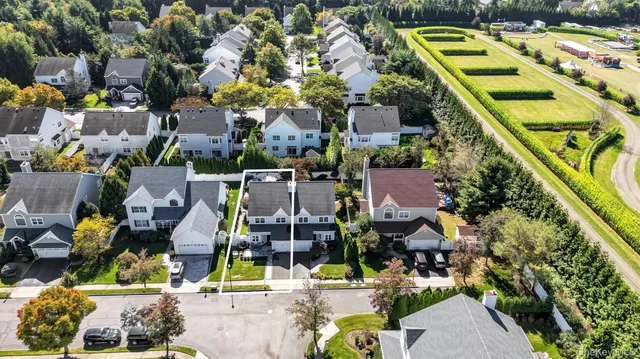 an aerial view of houses with yard