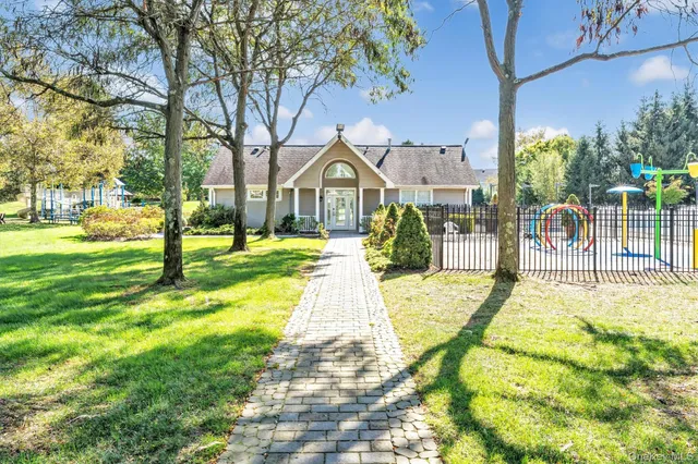 an aerial view of residential houses with swimming pool and outdoor space