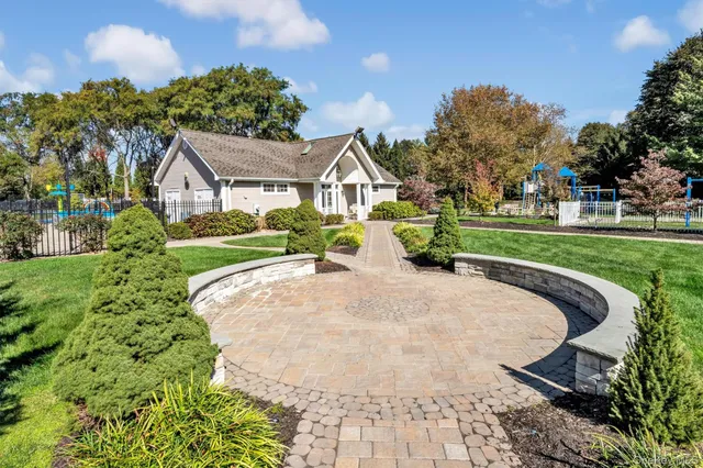a bathroom with a double vanity sink a large mirror and shower