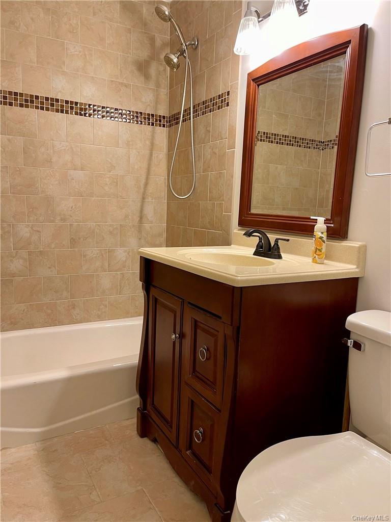 27 Tanager Road, Unit 2702 Monroe, NY 10950 - Photo 16 of 17 Bathroom featuring a dark wood-finish vanity with a light-toned countertop and integrated sink