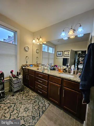 a large bathroom with a sink and a mirror