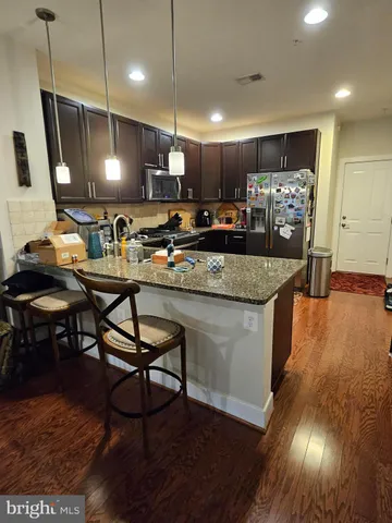 a large kitchen with a table and chairs in it