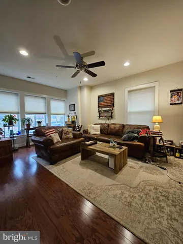 a living room with furniture and view of kitchen