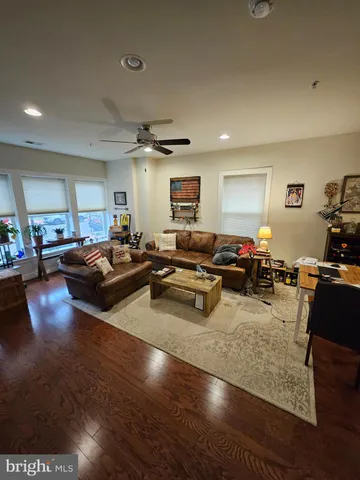 a living room with lots of furniture and a wooden floor
