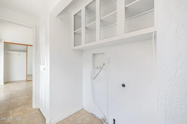 a view of a hallway with white walls and entryway