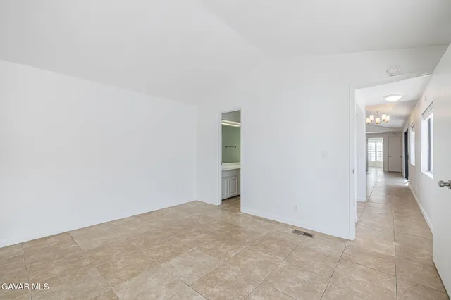 a view of an empty room with sliding glass door