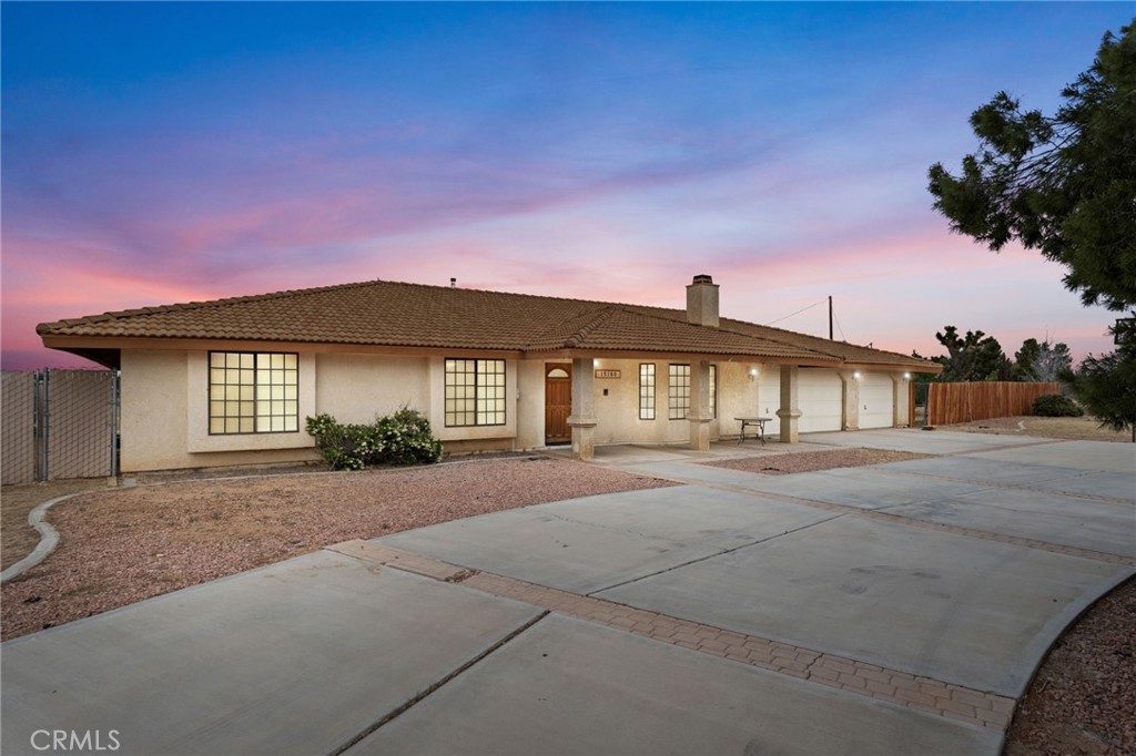 15160 Cheyenne Road Apple Valley, CA 92307 - Photo 1 of 55 a front view of a house with a yard