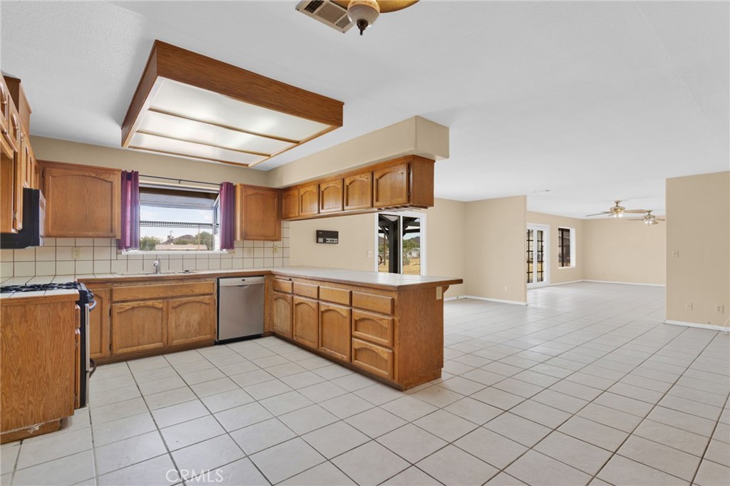 15160 Cheyenne Road Apple Valley, CA 92307 - Photo 16 of 55 a kitchen with stainless steel appliances granite countertop a sink and cabinets