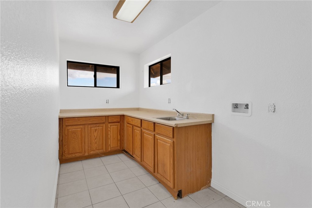15160 Cheyenne Road Apple Valley, CA 92307 - Photo 19 of 55 a kitchen with stainless steel appliances a refrigerator and cabinets