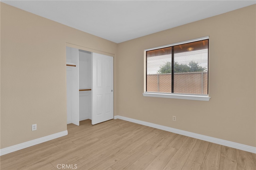 15160 Cheyenne Road Apple Valley, CA 92307 - Photo 29 of 55 an empty room with wooden floor and windows