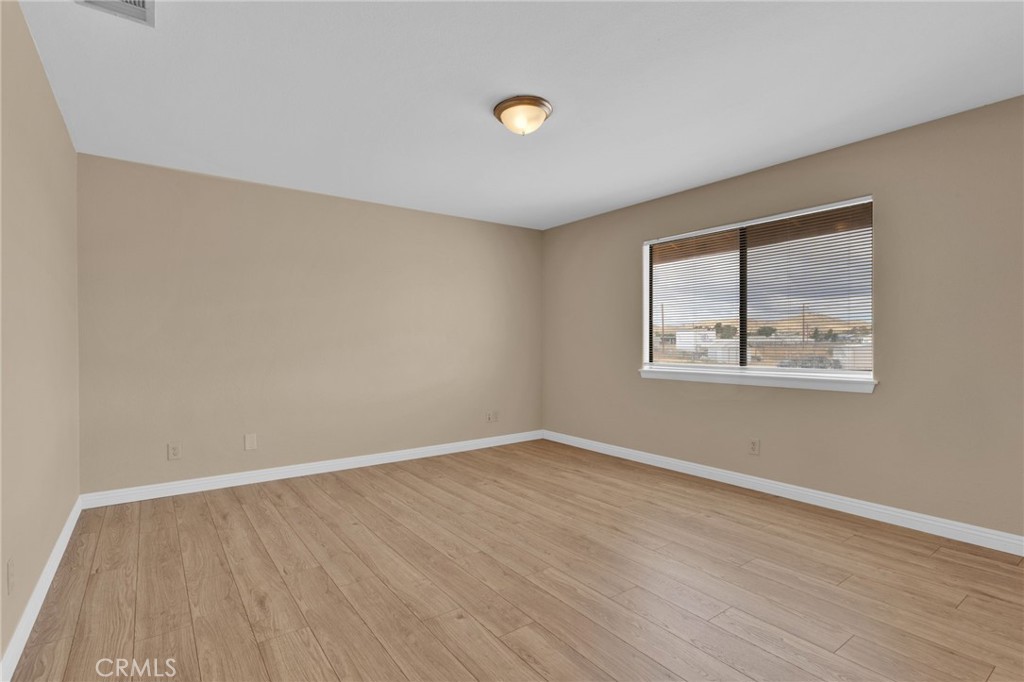 15160 Cheyenne Road Apple Valley, CA 92307 - Photo 30 of 55 wooden floor in an empty room with a window